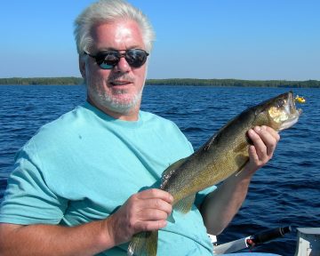 Guest Holding A Small Walleye